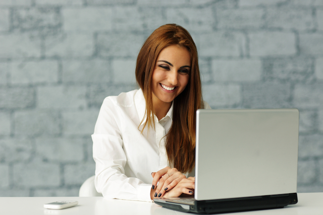 Young businesswoman working on laptop in office