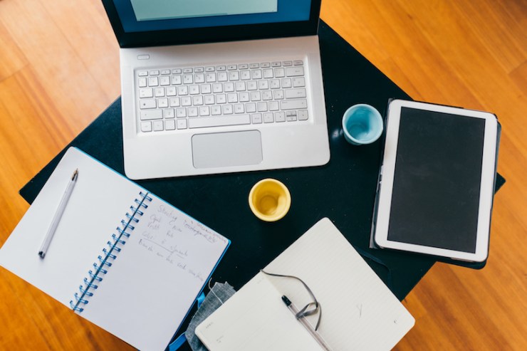 graphicstock-top-view-of-office-desk-table-with-organizer-notebook-tablet-pencil-and-cups-of-coffee-business-work-meeting-concept_HTvh9X5yW